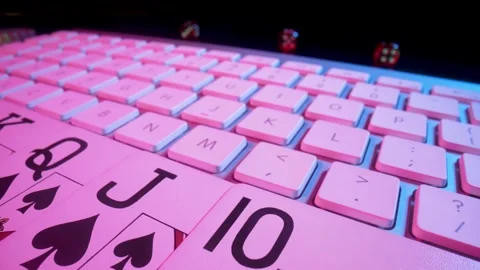 Computer keyboard and Royal Street Flush card combination, illuminated with pink Stock Footage 187501333
