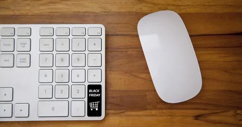 Computer keyboard with black friday key and shopping cart. Copy space and woo Фото