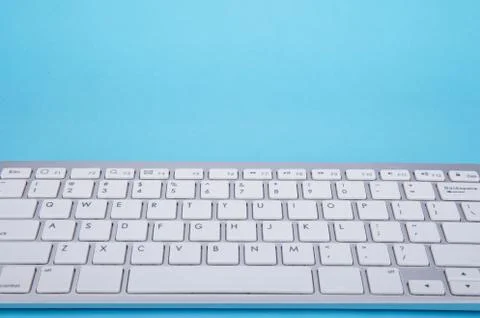 Computer keyboard on blue background Stock Photos