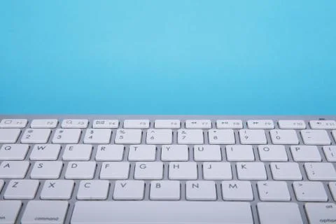 Computer keyboard on blue background Stock Photos