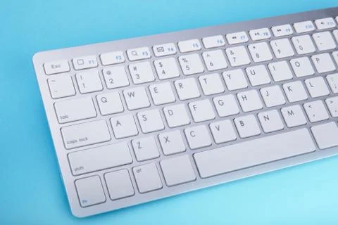 Computer keyboard on blue background Stock Photos