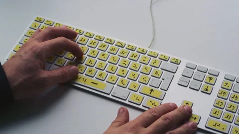 Computer keyboard with braille font alphabet. Blind person is typing words Stock Footage 319055181