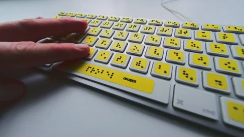 Computer keyboard with braille font alphabet. Blind person is typing words Stock Footage 319058844