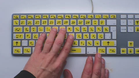 Computer keyboard with braille font alphabet. Blind person is typing words Stock Footage 319078394