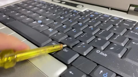 Computer keyboard close up view. Hand using screwdriver to fix and replace Stock Footage 264992770