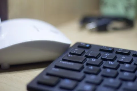 Computer keyboard closeup in black backlight Stock Photos