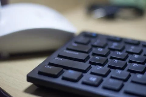 Computer keyboard closeup in black backlight Foto stock