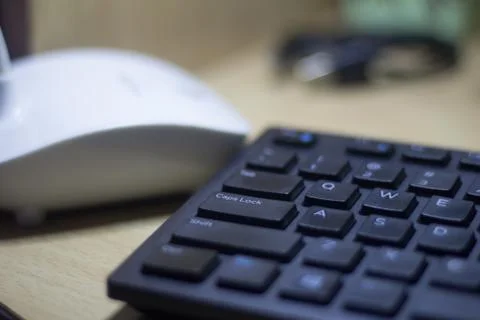 Computer keyboard closeup in black backlight Stock Photos