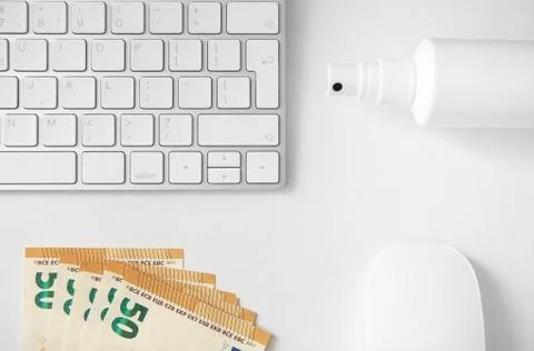 Computer keyboard, computer mouse,disinfectant spray and money. Stock Photos