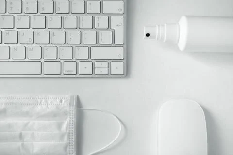 Computer keyboard, computer mouse,disinfectant spray and mask. Stock Photos