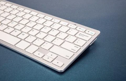 Computer keyboard on dark blue background Stock Photos