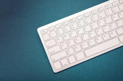 Computer keyboard on dark blue background 스톡 사진