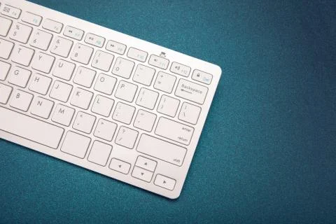 Computer keyboard on dark blue background Stock Photos