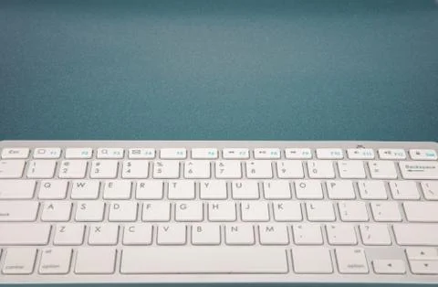 Computer keyboard on dark blue background Stock Photos