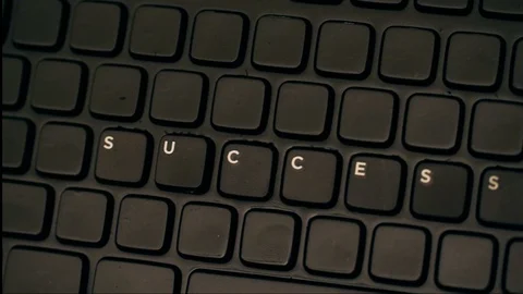 Computer keyboard displayin g the word success only Stock Footage 98658747
