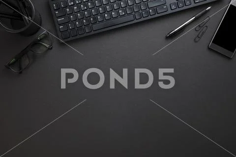 Computer Keyboard With Eyeglasses And Office Supply On Gray Desk Stock-Fotos