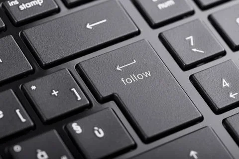 Computer keyboard with "follow" button, selected focus on enter button Stock Photos