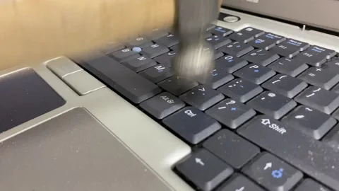 Computer keyboard. Hand using hammer trying to hit and damage the laptop Stock Footage 264992520