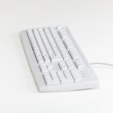 Computer keyboard lies on table surface Stock Photos
