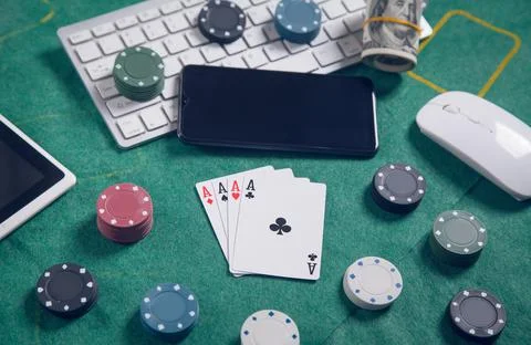 Computer keyboard, money, mouse, playing cards and chips. Online casino Stock Photos