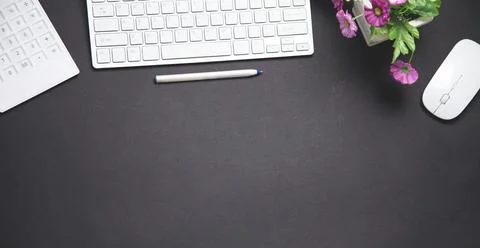 Computer keyboard, mouse, pen, calculator. Modern black business desk. Office Stock Photos