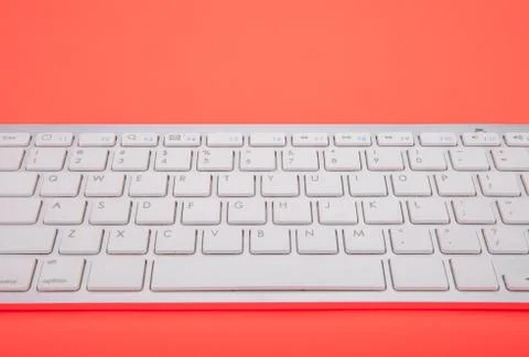Computer keyboard on orange background Stock Photos