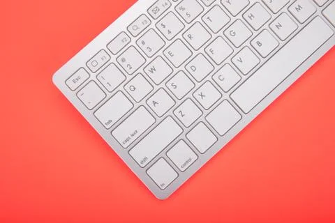 Computer keyboard on orange background Stock Photos