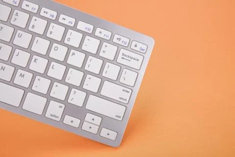 Computer keyboard on orange background 스톡 사진