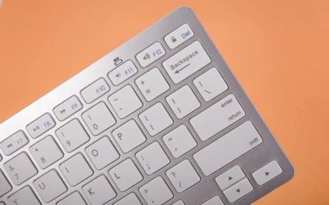 Computer keyboard on orange background Stock Photos