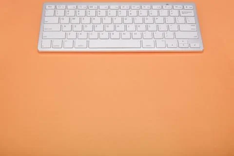 Computer keyboard on orange background 스톡 사진