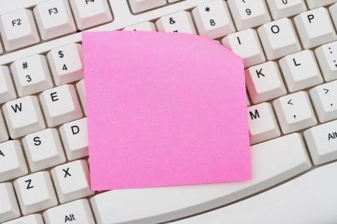 Computer Keyboard with a pink blank sticky note Stock Photos