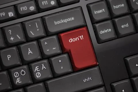 Computer keyboard with a red button saying dont. Stock Photos