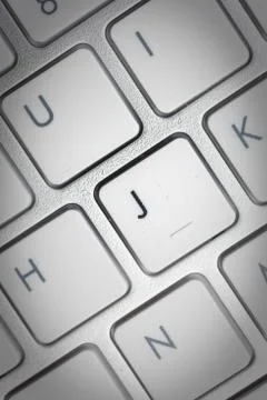 Computer keyboard - silver keyboard of a laptop with button J isolated. Home  Foto stock