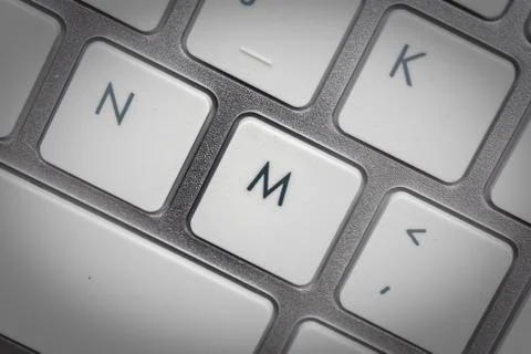 Computer keyboard - silver keyboard of a laptop with button M isolated. Home  Stock Photos
