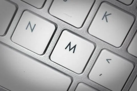 Computer keyboard - silver keyboard of a laptop with button M isolated. Home  Stock Photos