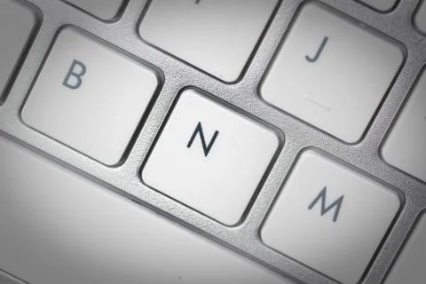 Computer keyboard - silver keyboard of a laptop with button N isolated. Home  Stock Photos