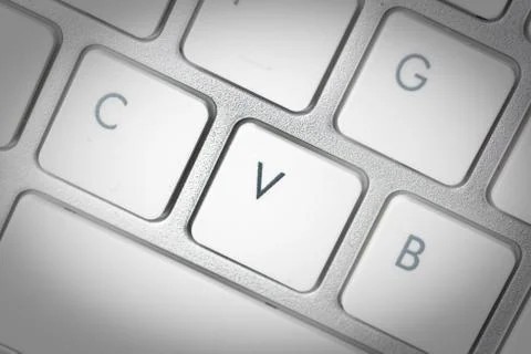 Computer keyboard - silver keyboard of a laptop with button V isolated. Home  Stock Photos