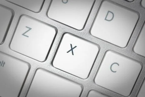 Computer keyboard - silver keyboard of a laptop with button X isolated. Home  Stock Photos