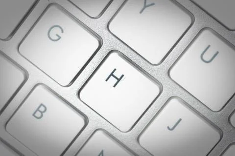 Computer keyboard - silver keyboard of a laptop with button H isolated. Home  Stock Photos