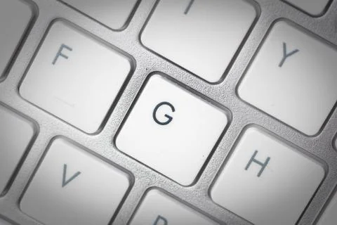 Computer keyboard - silver keyboard of a laptop with button G isolated. Home  Stock Photos