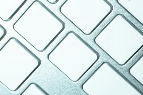 Computer keyboard - silver keyboard of a laptop with blank buttons. Home offi Stock Photos
