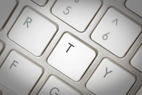 Computer keyboard - silver keyboard of a laptop with button T isolated. Home  Stock Photos