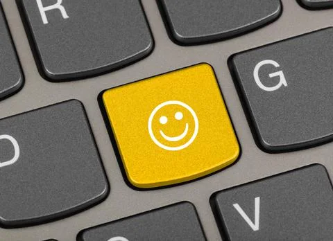 Computer keyboard with smile key Stock Photos