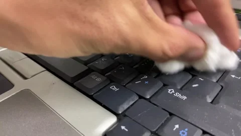 Computer keyboard. Spraying on keys, hand using white cotton to wipe dirt off Stock Footage 264992923