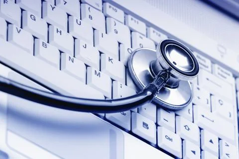 Computer keyboard with stethoscope. Good technical support symbol Stock Photos