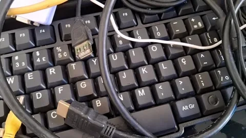 Computer keyboard with various cables. Electronic hardware and digital Stock Footage 340241503
