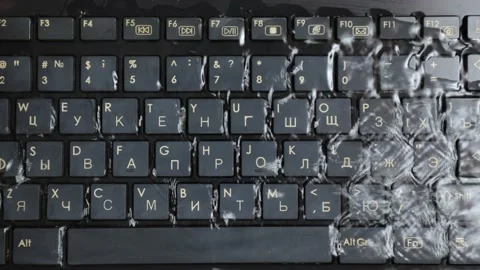 The computer keyboard was filled with water. Water soaked the keyboard keys Stock Footage 230681675