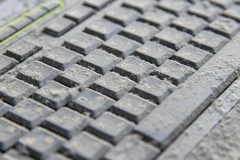The computer keyboard was idle for a long time, covered with a layer of dust. Stock Photos
