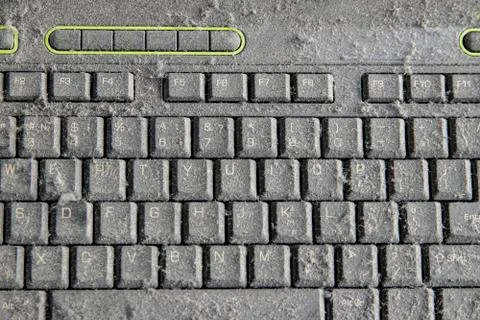 The computer keyboard was idle for a long time, covered with a layer of dust. Stock Photos