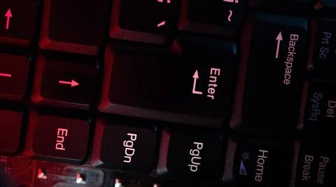 The computer keyboard, which is shot close to the abstract lights, is pressed Stock-Fotos